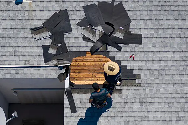 Workers repairing part of a roof