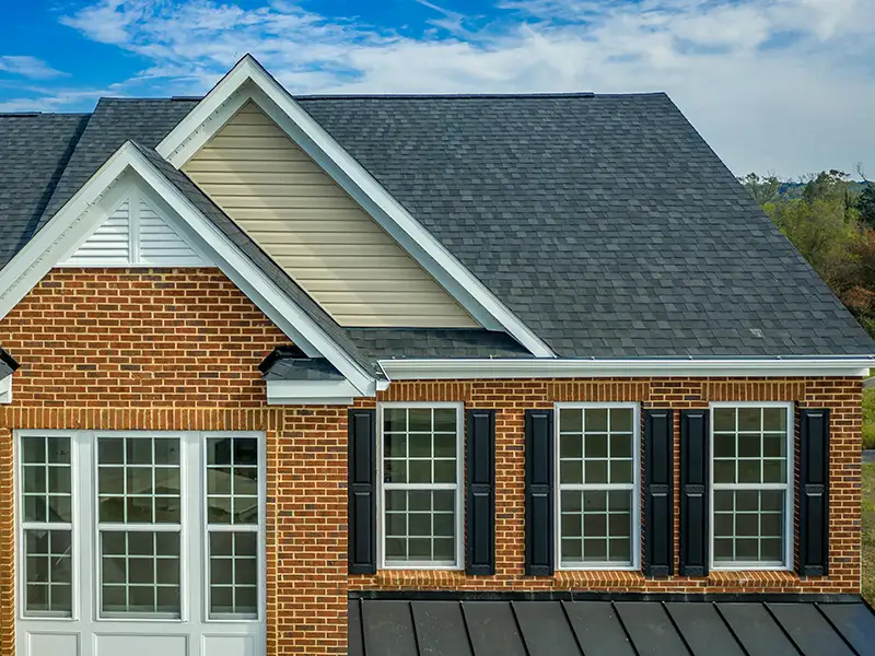 Home with black shingle and metal roofs
